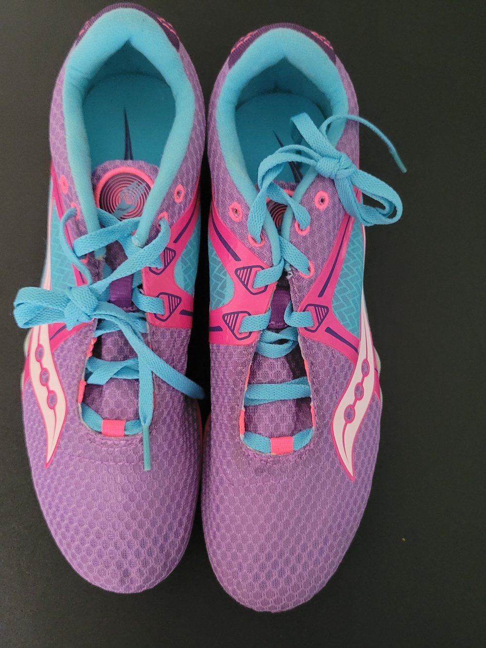 Saucony Velocity 5 track and field spikes in a purple, pink, and light-blue